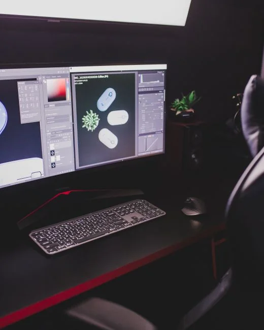A modern computer screen displaying web design work, showcasing creative visuals in a workspace.