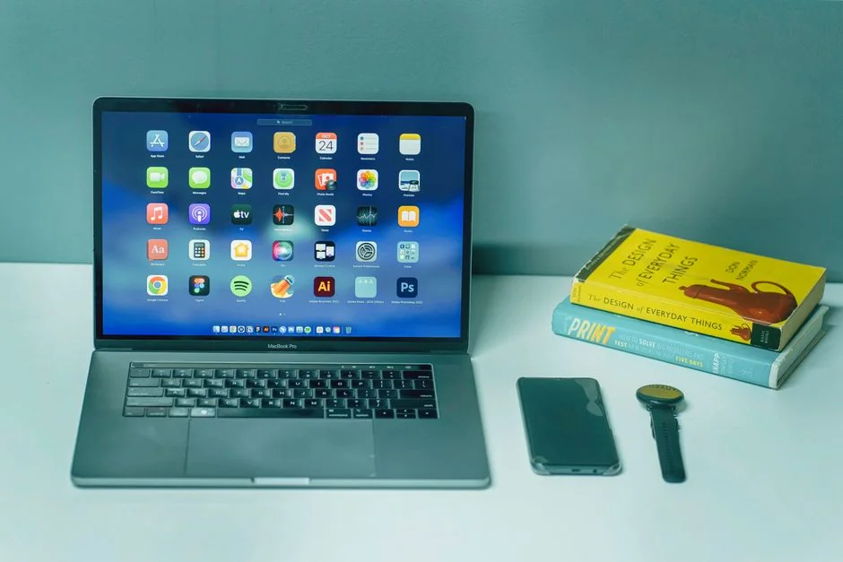 A contemporary workspace showcasing a laptop, tablet, and smartphones, ideal for tech and freelance use.